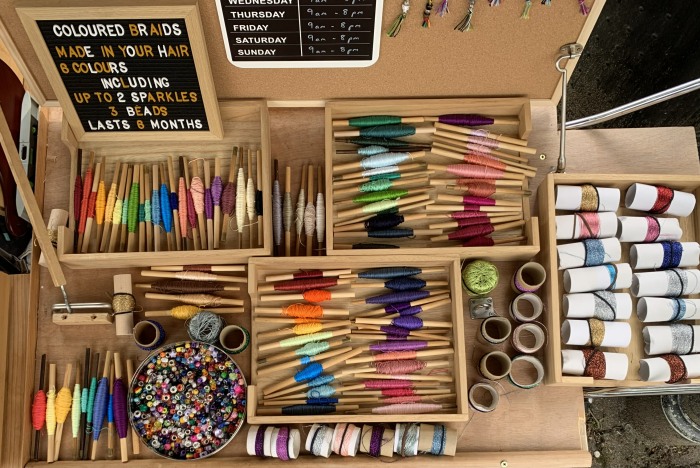 Hair braiding stall in Salcombe